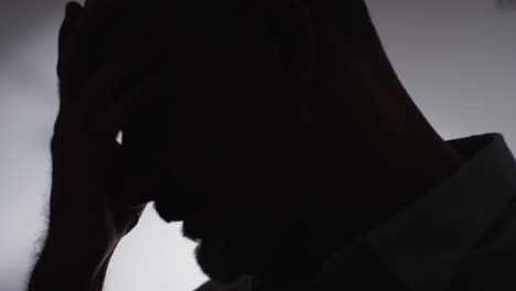 Close-Up-Silhouette-Of-Depressed-Mature-Man-Struggling-With-Mental-Health-In-Slow-Motion-1