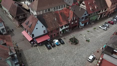 a footage moving onwards across a parking lot within the village