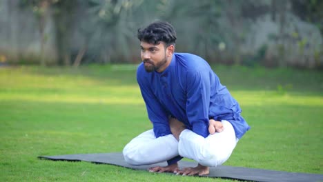 Indian-man-lifting-himself-from-ground-and-doing-a-yoga-pose