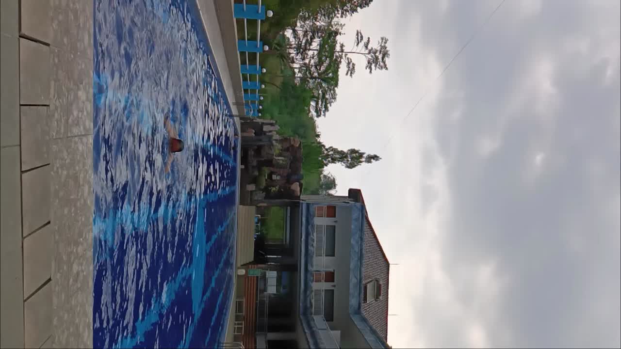 Men swim in the swimming pool in luxury restaurants with a cloudy sky background