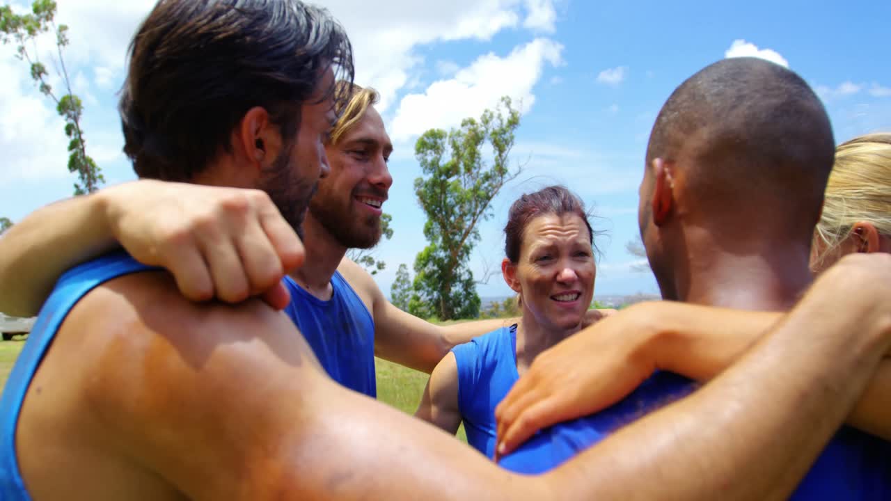Fit people standing together and forming a hurdle 4k