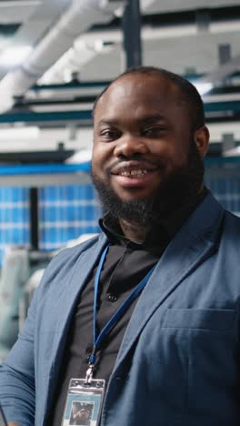 vertical video african american technician analyst in a solar manufacturing plant