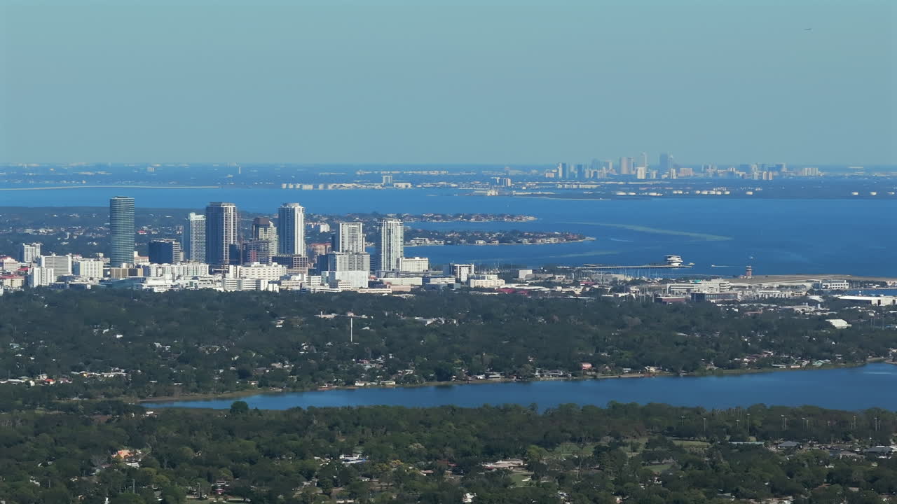 Expansive aerial view showcasing Downtown Saint Petersburg skyline in foreground with Downtown Tampa visible across Tampa Bay, highlighting Florida's dual-city metropolitan corridor