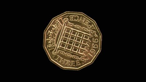 United Kingdom 1966 threepence coin reverse with Tudor portcullis and chains rotating on black background