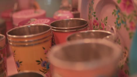 close up shot of beautiful steel dustbins in a row with colorful paintings of flowers