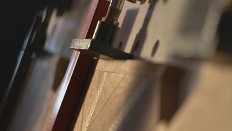 closeup of a industrial clamp machine, clamping wood in a furniture manufacturing plant