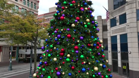 american flag and decorated christmas tree for holidays in downtown usa city