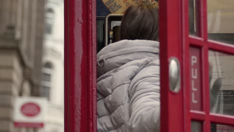 Entering-a-public-payphone-in-England