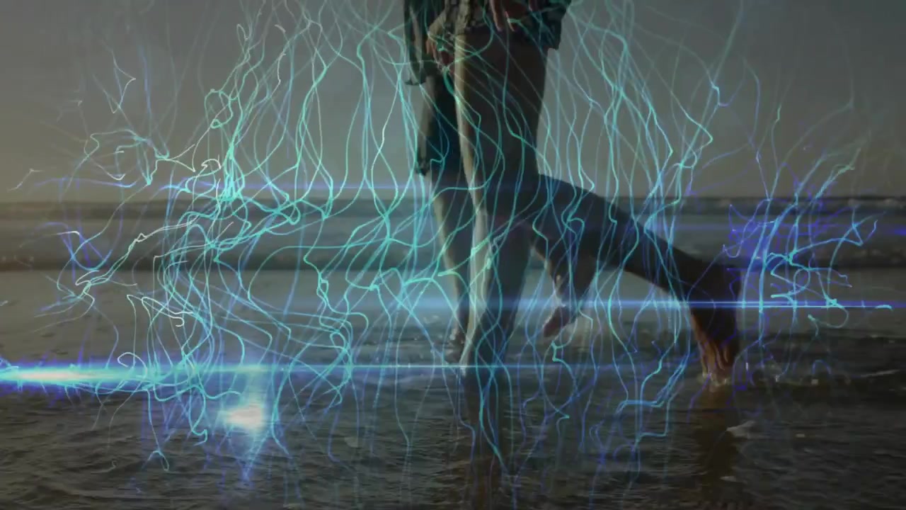 Dance duo shifting weight and stepping forward causing light trails tracing motions on sunset sea