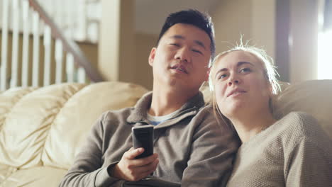 young multi-etna couple watch tv together