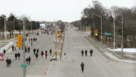 people are walking on the road in the morning