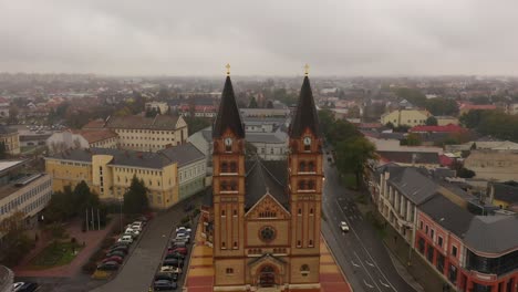 drone footage from a church in autumn rainy weather nyiregyhaza, hungarydrone flies backwards and up between the towers