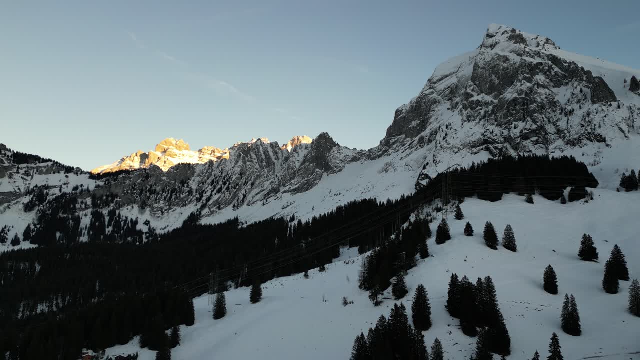 Fronalpstock Switzerland Glarus flying over forest towards sunny Swiss alps