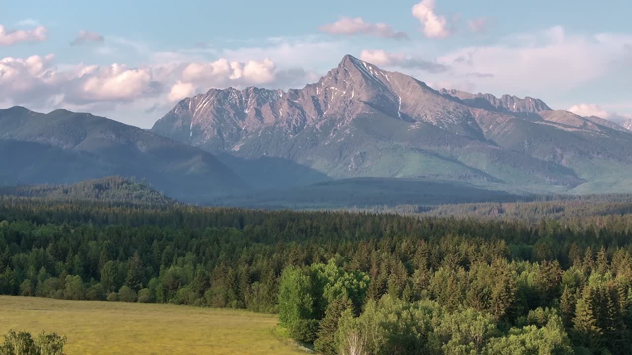 daytime mountain landscape dynamic slow stable drone shot in alpine environment and vivid green lush grass