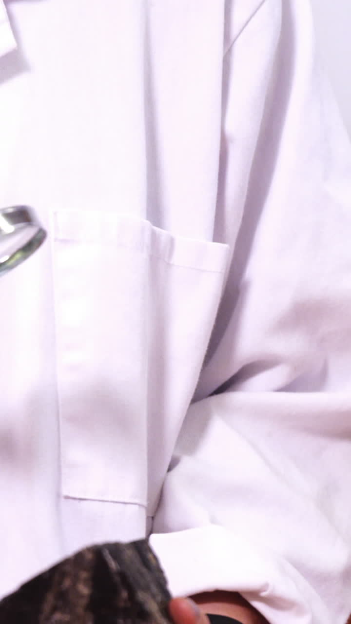 Teacher using magnifying glass over rock while teaching a students