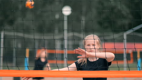 Women-Competing-in-a-Professional-Beach-Volleyball-Tournament.-A-defender-attempts-to-stop-a-shot-during-the-2-women-international-professional-beach-volleyball.