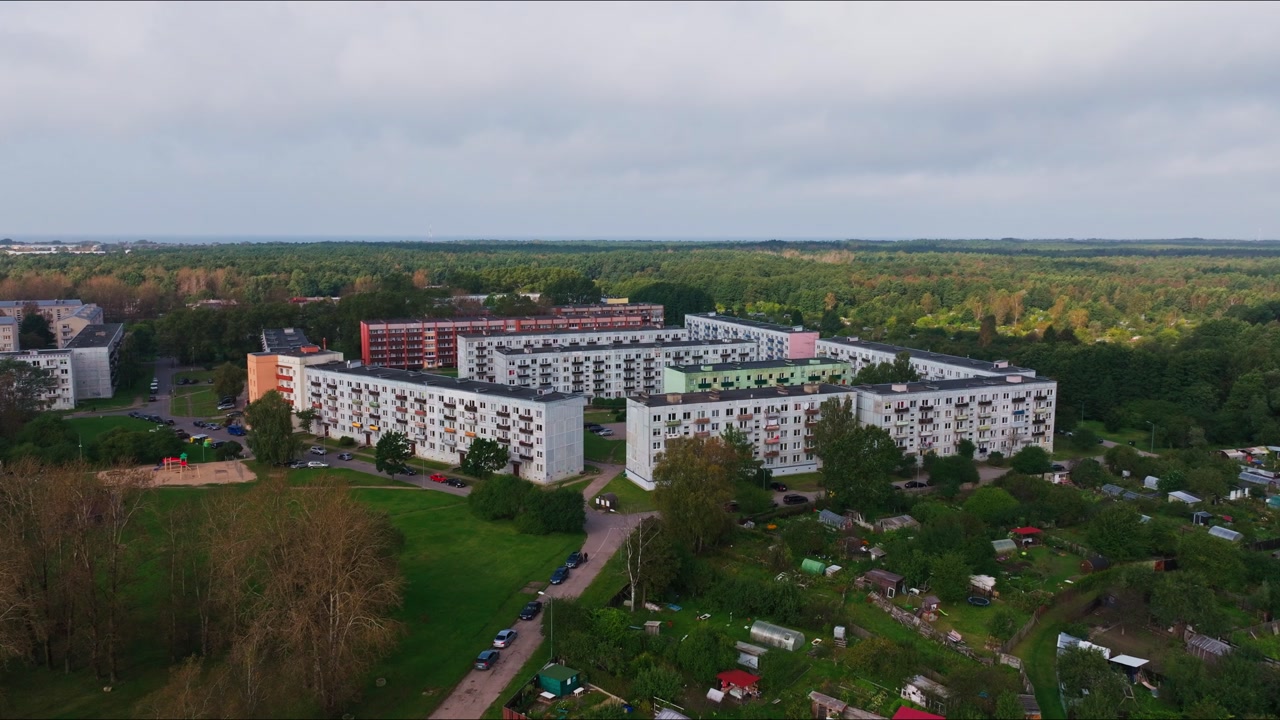 Overcast aerial shows residential district near forest Liepaja Latvia