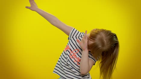 Cheerful-little-kid-child-girl-having-fun-dancing-and-moving-to-rhythm,-dabbing-raising-hands