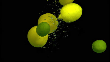 lemons and limes splashing underwater