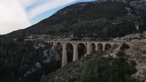 valley-bridge-taken-with-drone,-historical-big-bridge