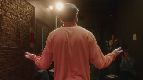 Actor Bowing from Theater Stage after Solo Performance