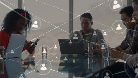 web of connection icons against people working in office