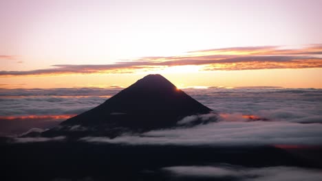 the sun rises behind volcán de agua in guatemala