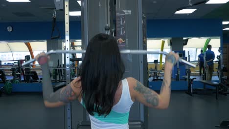 woman performing lat pulldown exercise in a gym