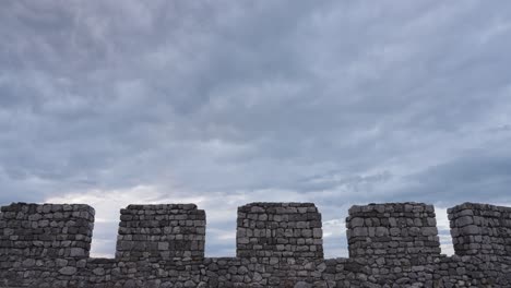 Dramatic cloudy sky above the ancient stone walls of Rozafa Castle in Albania
