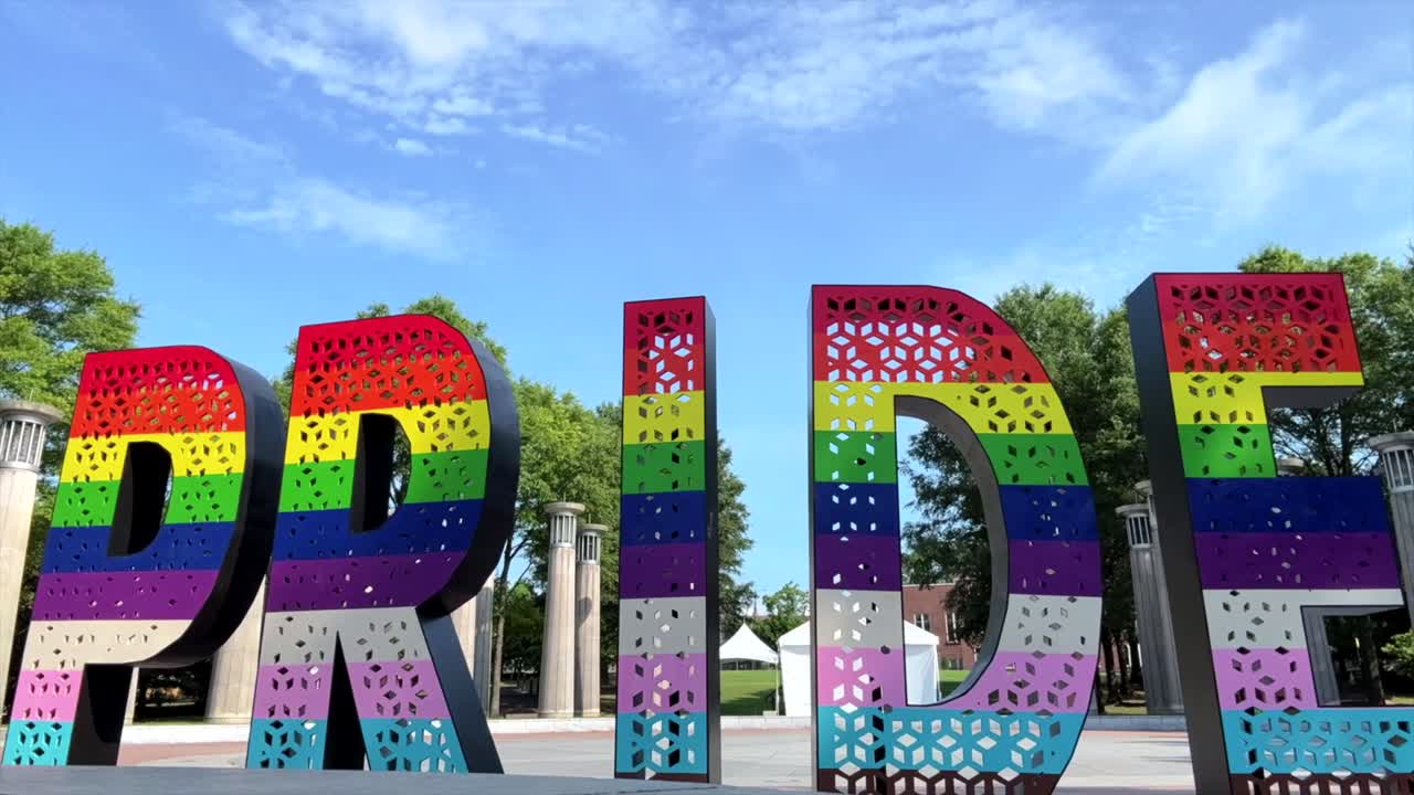 Time Lapse of large colorful Pride metal sign in Bicentennial park from June event or concert
