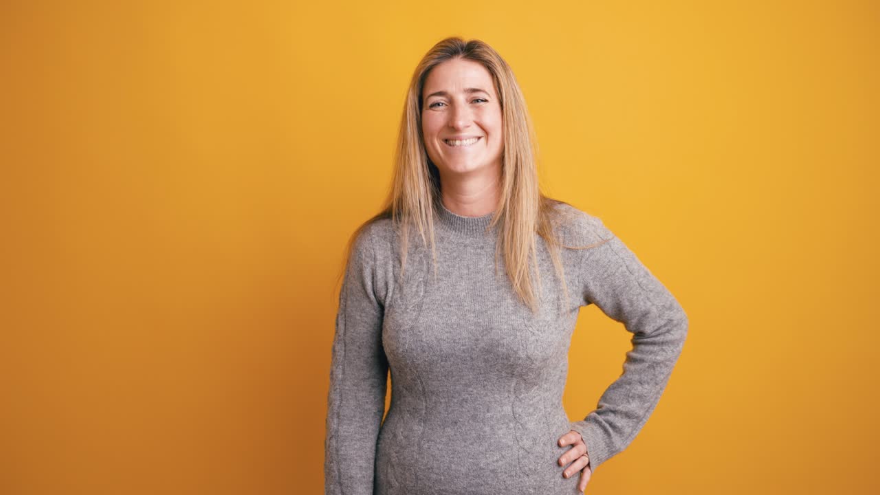 Happy Woman Smiling and Posing on Yellow Background