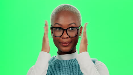 portrait of a smiling woman with glasses in front of a green screen