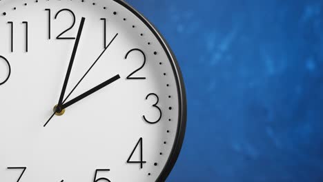 white wall clock on blue background. time concept.