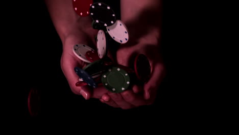 poker chips falling into hands