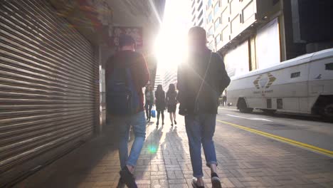 tracking behind couple walking in hong kong