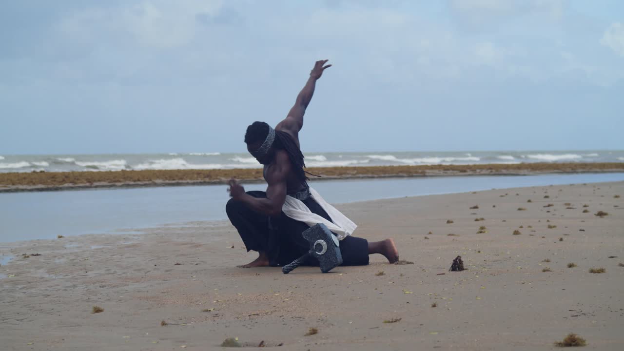 On a tropical beach, a muscular, dark-skinned man in Nekharis cosplay is a striking sight