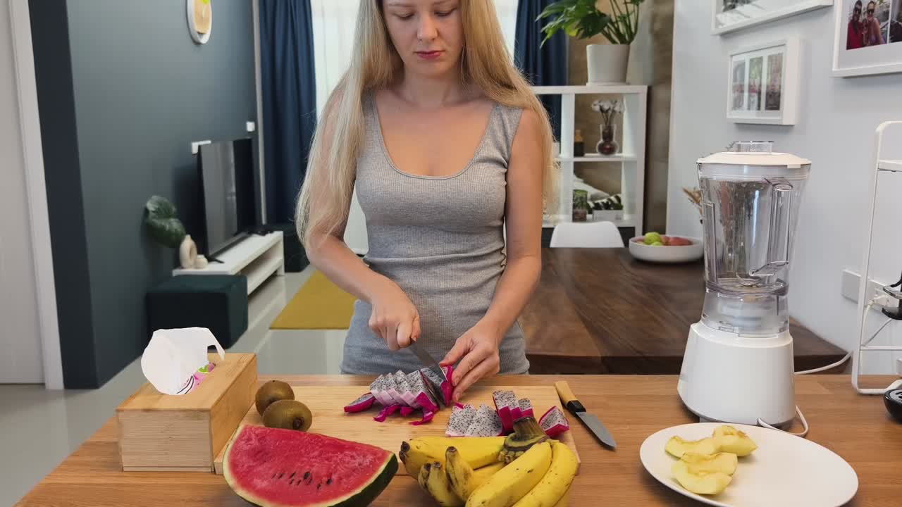 una mujer preparando un batido de frutas.