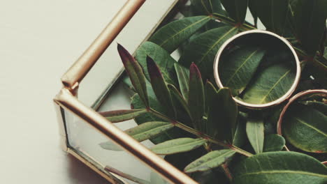 close-up of gold wedding rings with flowers