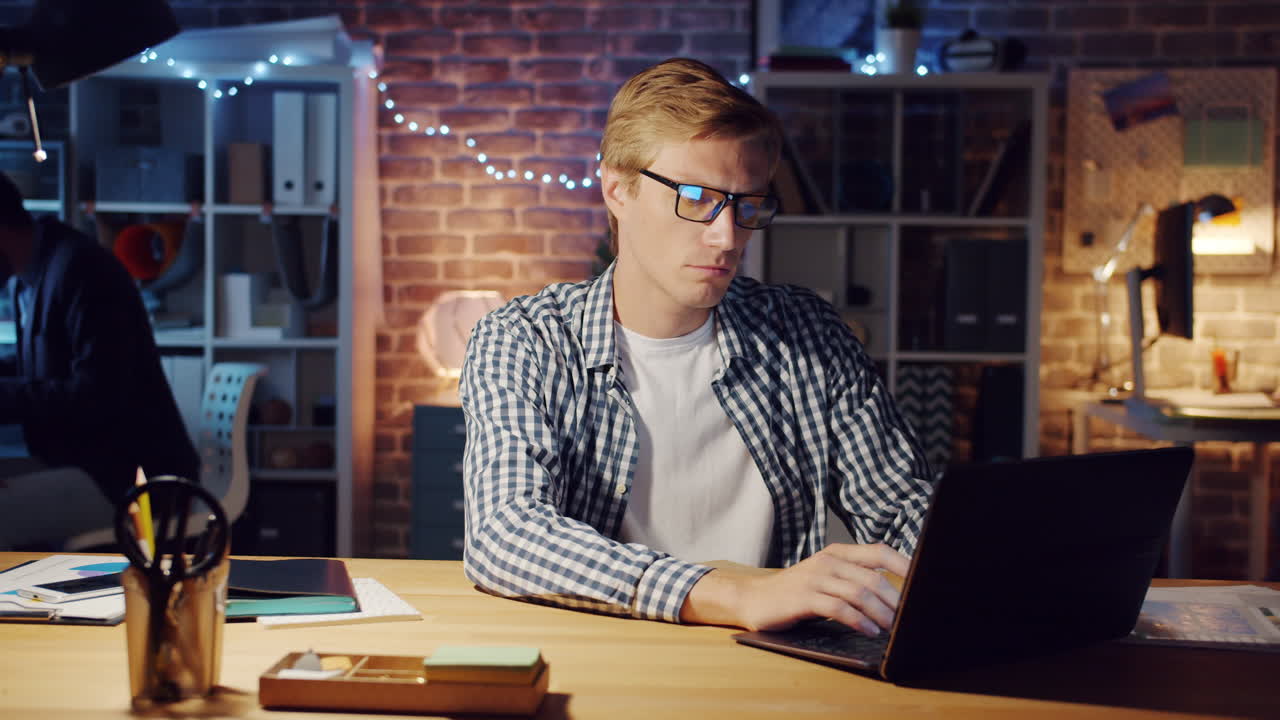 Man Working Late at Night on Laptop