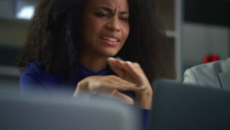 African-american-woman-boss-talking-business-idea-on-laptop-video-call-in-cafe.