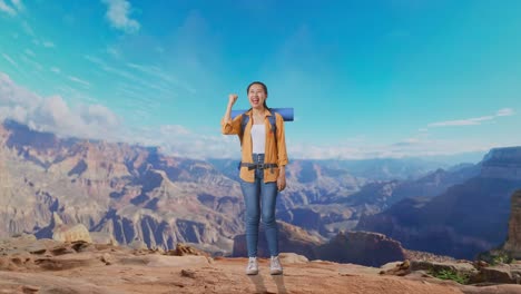 full body of asian female hiker with mountaineering backpack screaming goal celebrating the success while traveling at the top of mountain