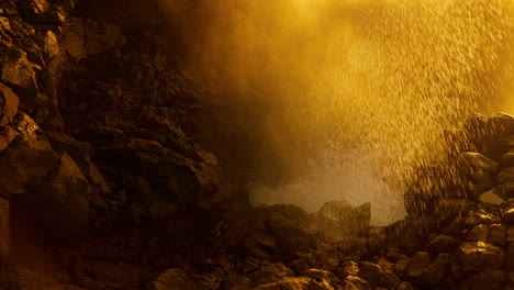 golden waterfall in a volcanic cave