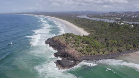 fingal head and foamy waves of the tasman sea in new south wales, australia - aerial drone shot