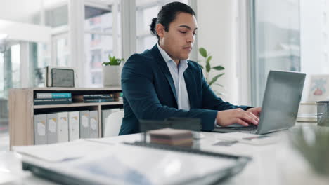 serious, laptop typing and business man in office