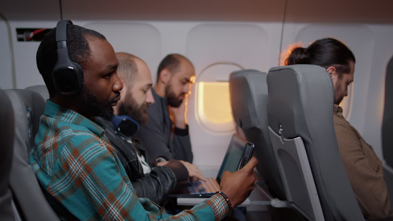 African american passenger browsing internet on mobile phone