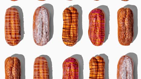 animación de bucle sin costuras con eclairs frescos en un fondo blanco. patrón con sombras duras de moda vista superior