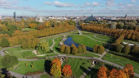establishing shot of riga park with blue sky, clouds, and vivid fall colors
