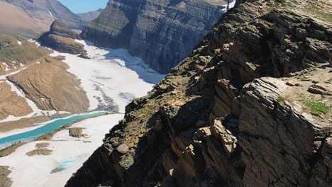 camera captures a closed shot of the mountains overlooking the glacial valley during the summer months