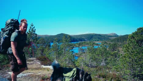 norwegian guy with alaskan malamute dog breed over scandinavian hiking routes