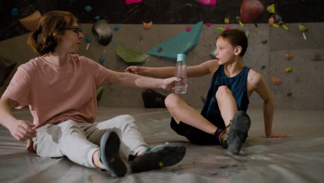 teenage boys resting in a climbing gym